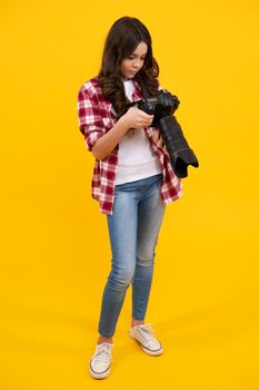 Teenager lifestyle, teen hipster hold professional camera. Girl with photo camera photographing, isolated on studio background