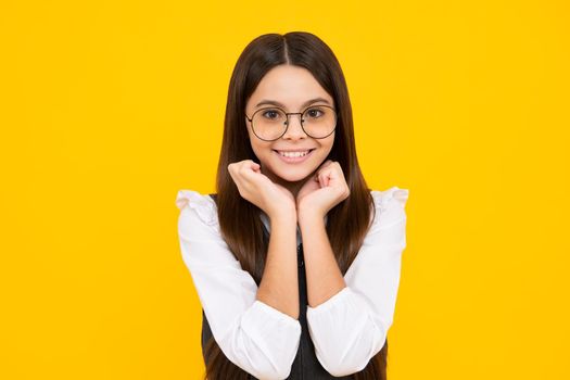 Happy girl face, positive and smiling emotions. Emotional portrait of caucasian teenager child girl isolated on studio yellow background