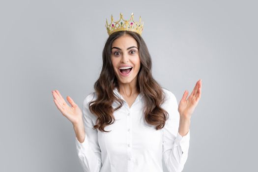 Amazing overjoyed woman queen wear golden crown, isolated gray background