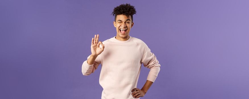 Portrait of enthusiastic young relaxed man show no problem, guarantee gesture, recommend awesome courses where you easily learn new languages, smiling and show ok to assure you.