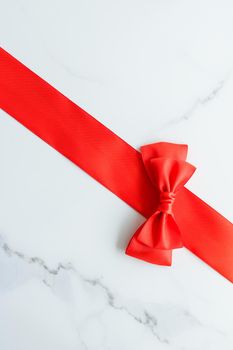 Holiday decor, feminine design and flatlay concept - Red silk ribbon on marble, top view