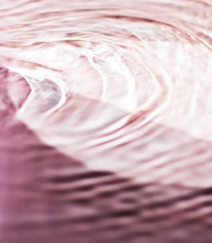 Pink flowing water texture as an abstract background - colourful liquids and creative designs concept. Pink flow