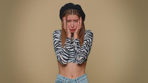 Dissatisfied pretty young woman asking reason of failure, expressing disbelief irritation, feeling bored, disappointed in result, bad news. Adult stylish girl isolated alone on beige studio background