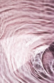Pink flowing water texture as an abstract background - colourful liquids and creative designs concept. Pink flow