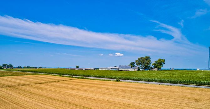 Aerial View of Farmlands and a Railroad Track, With Corn and Wheat Fields on a Beautiful Sunny Day
