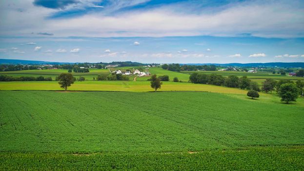 Drone View of Amish Countryside With Barns and Silos, a Patch Work of Corps and Farmlands on Sunny Day.