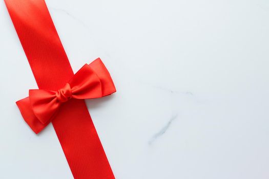 Holiday decor, feminine design and flatlay concept - Red silk ribbon on marble, top view