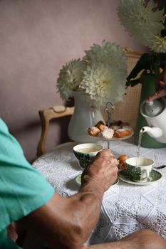 tea break in english style, vintage retro still life, homemade buns and a bouquet of white dalias. High quality photo