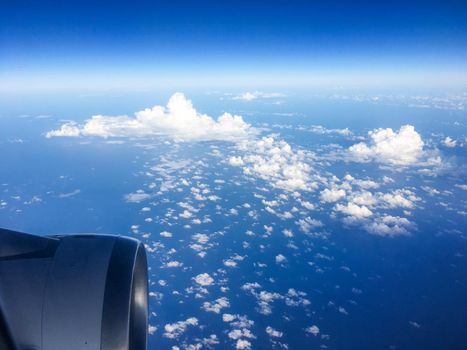 Travel, cloudscape and natural environment concept - View from the airplane window, sky and ocean blue