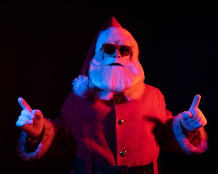 Portrait of Santa Claus in sunglasses in neon light