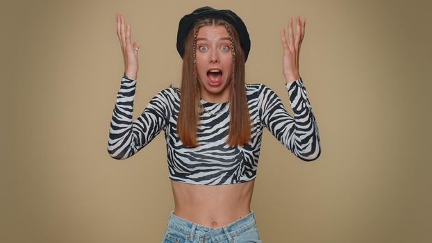 Excited amazed young woman touching her head and showing explosion, looking worried and shocked, professional burnout. Girl looking shocked surprised wow showing hands brain head explosion gesture