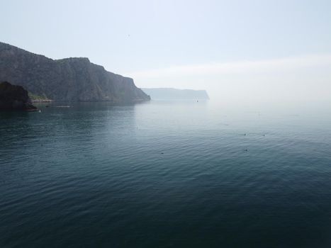 Aerial panoramic view of beautiful sunset above sea. Beautiful seascape. Sun glare, small waves on the water surface. Evening. Horizon. Nobody. No people. Copy space. Never-ending beauty of nature