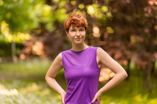 Portrait of a non-binary gender person looking at the camera standing in a park