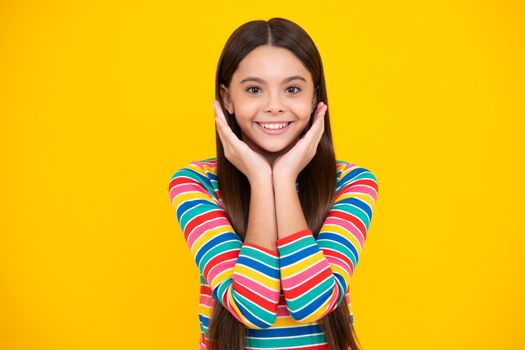 Happy face, positive and smiling emotions of teenager girl. Emotional portrait of caucasian teenager child girl isolated on studio yellow background