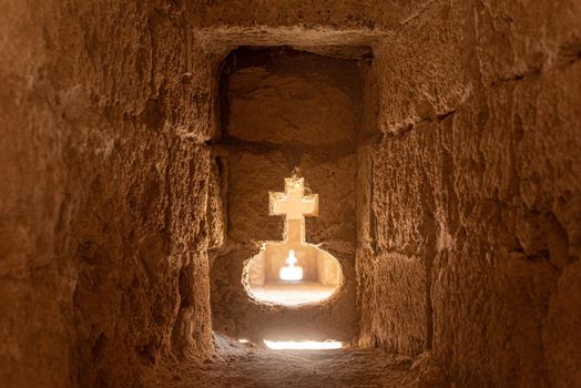 Perspective view of entrance passage carved in form of divine cross in ancient stone cave of Citadel of Almeria city in Spain