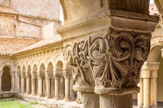 Exterior of ornamental shabby stone column with Romanesque art in Colegiata de Santa juliana in Cantabria Spain