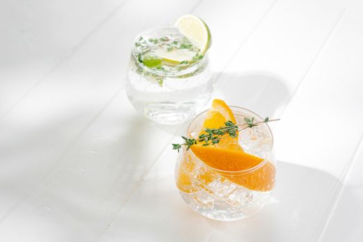 two glasses with an alcoholic cocktail on a light background. hard seltzer is a low-alcoholic drink.