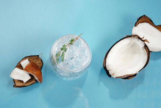 Alcoholic cocktail hard seltzer with coconut on blue background. Top view