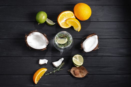 hard seltzer with different ingredients on a black wooden background top view. Strong seltzer cocktails with lime. Alcoholic cocktail tonic clear. hard seltzer is a low-alcohol drink consisting of alcohol, carbonated water and fruit, berry and herbal flavorings. Top view