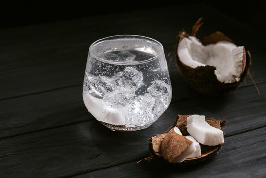 Alcoholic cocktail hard seltzer with coconut on black background. hard seltzer is a low-alcohol drink consisting of alcohol, carbonated water and fruit, berry and herbal flavorings