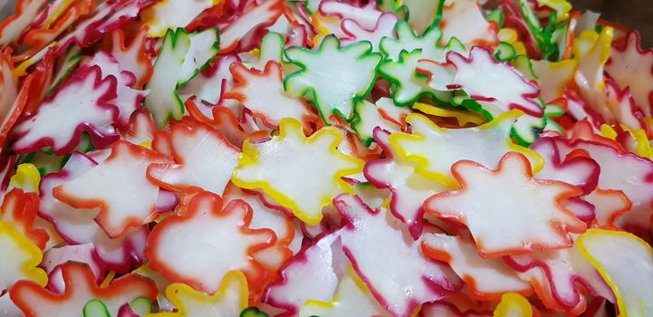 Onion rice flour crackers or Indonesian called it Kerupuk bawang mentah or kerupuk warna-warni or raw kerupuk bawang is rice crackers, Indonesian traditional dish. Selective focus.