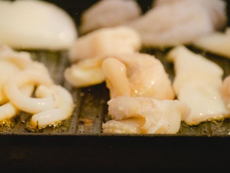 grilling a raw adriatic cuttlefish at home in Numana, Marche, Italy