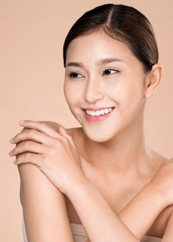 Portrait of ardent young woman with healthy clear skin and soft makeup looking at camera and posing beauty gesture. Cosmetology skincare and beauty concept.