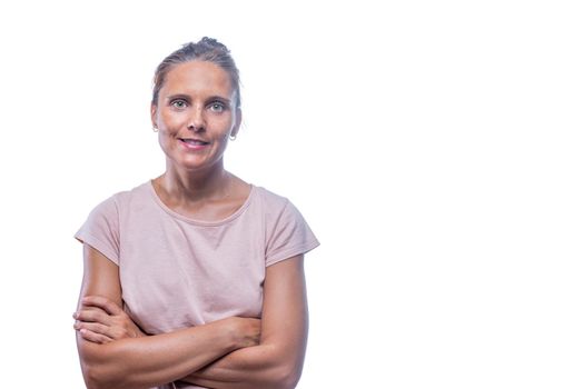 Front view of a green-eyed woman with her crossed arms looking at camera on a white background with copy space.