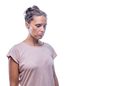 Front view of a sad woman looking down on a white background with copy space.