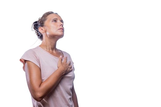 Front view of a woman with her hand on her chest showing patriotism on a white background with copy space.