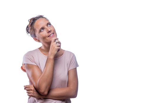 Front view of a dreamy green-eyed woman looking up on a white background with copy space.