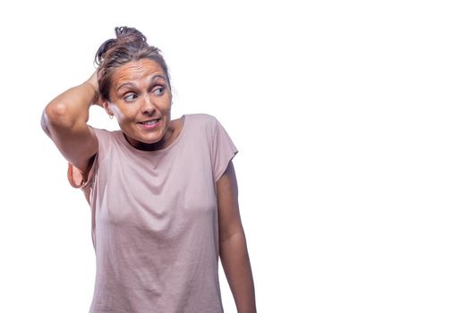 Front view of an embarrassed green-eyed woman looking to a side on a white background with copy space.