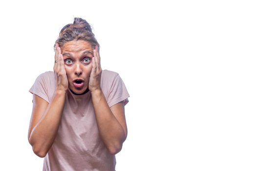 surprised green-eyed woman with hands on her face looking at camera and open mouth on a white background with copy space.