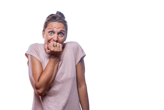 Front view of a green-eyed woman with her hand over her mouth on a white background with copy space.