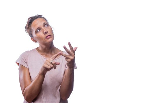 Front view of a pensive green-eyed woman counting on her fingers on a white background with copy space.