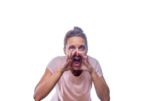 Front view of a green-eyed woman looking at camera screaming with her hands in her mouth on a white background with copy space.