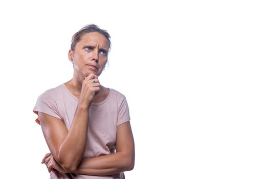 Front view of a thoughtful and concerned green-eyed woman on a white background with copy space.