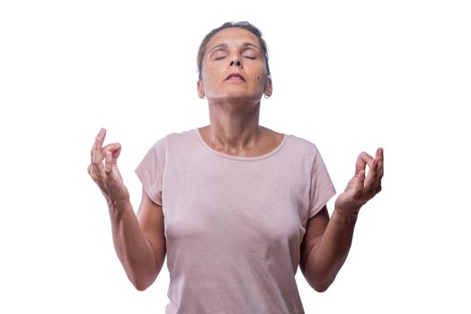 Front view of a woman standing meditating on a white background.