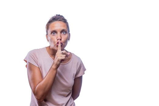 Front view of a green-eyed woman gesturing silence while looking at camera on a white background with copy space.