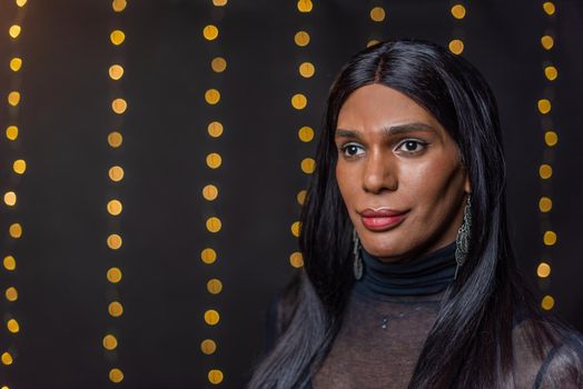 Portrait of a transgender person looking away with a blurred light background with copy space