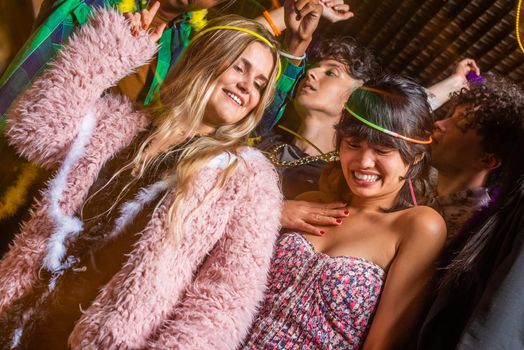 Low angle view of young women having fun with their friends in a party