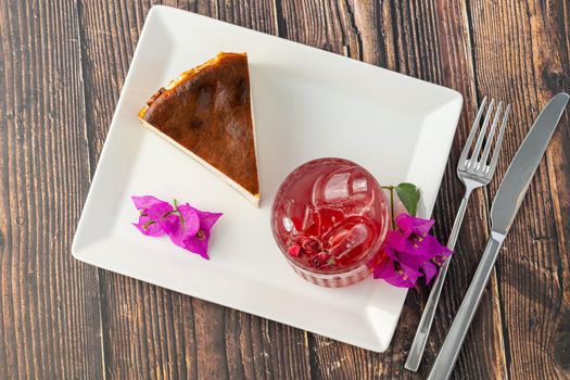 Strawberry tea and san sebastian cheesecake on wooden table