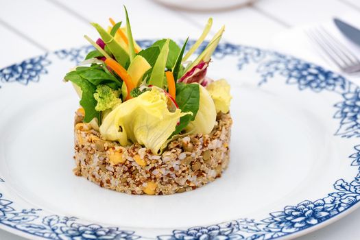 Quinoa salad with avocado, carrot, chickpeas and fresh greens