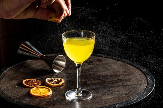 Refreshing citrus and alcoholic cocktail on dark background