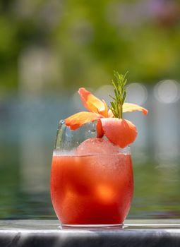 Refreshing citrus and alcoholic cocktail on dark background