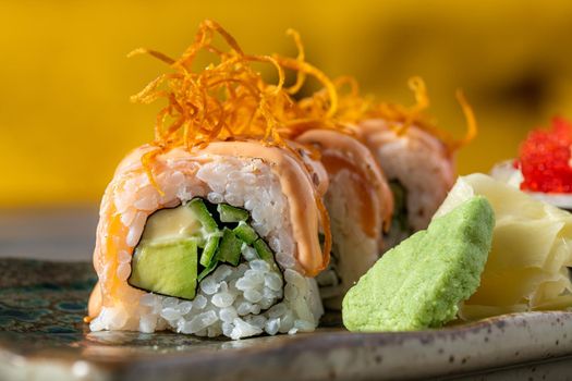 Sushi set of various products on a stone plate. Blur background and selective focus