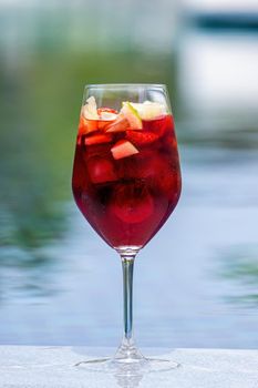 Refreshing fruity and alcoholic summer cocktail on dark background