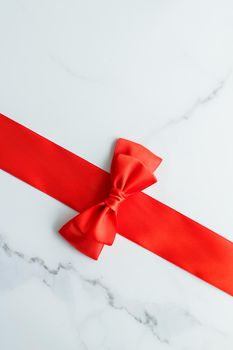 Holiday decor, feminine design and flatlay concept - Red silk ribbon on marble, top view