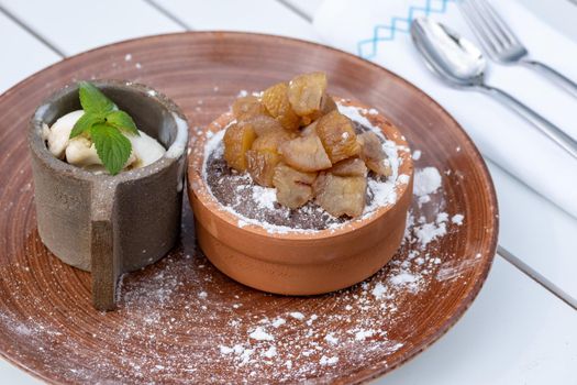 Souffle with chestnut in a casserole and ice cream with cream