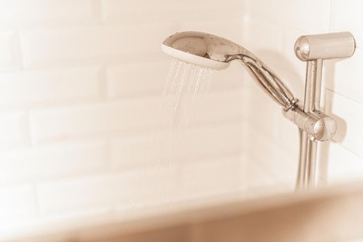 Close up view of a rainfall head shower in a hotel with copy space. Concept of bahtroom in hotel.